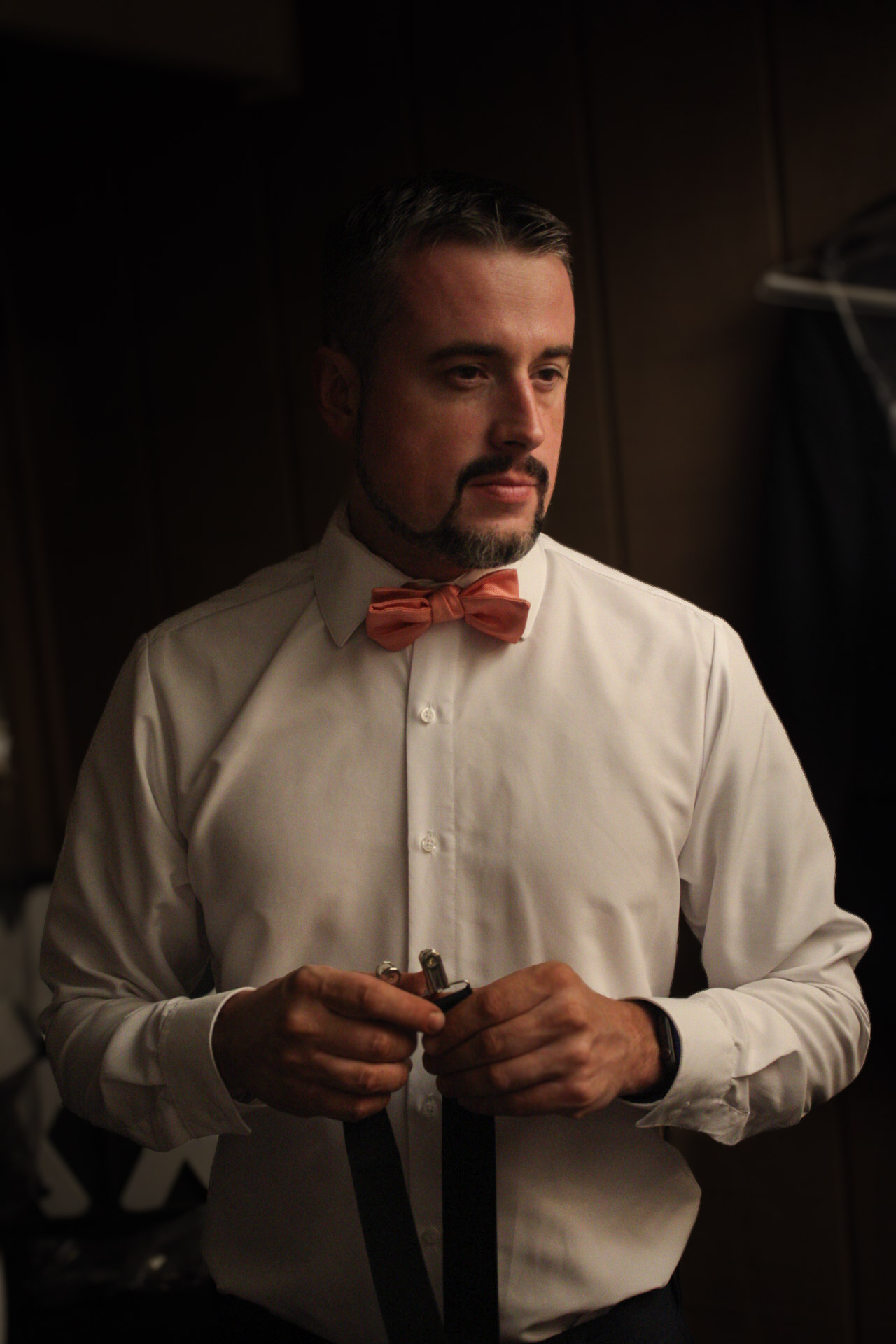 Groom portrait adjusting tie before ceremony